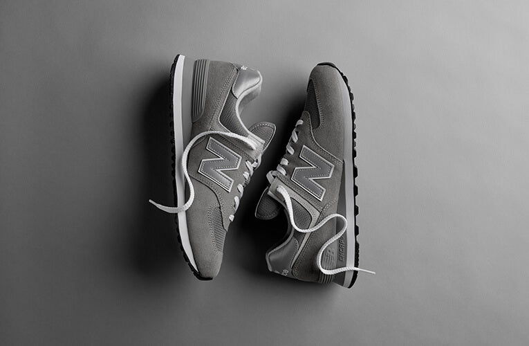 Pair of Gray New Balance trainers with white laces